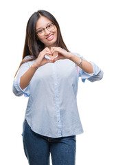 Wall Mural - Young asian business woman wearing glasses over isolated background smiling in love showing heart symbol and shape with hands. Romantic concept.