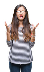 Poster - Young asian woman wearing glasses over isolated background crazy and mad shouting and yelling with aggressive expression and arms raised. Frustration concept.