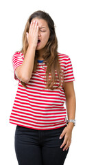 Poster - Young beautiful brunette woman wearing stripes t-shirt over isolated background Yawning tired covering half face, eye and mouth with hand. Face hurts in pain.