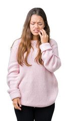 Poster - Young beautiful brunette woman wearing pink winter sweater over isolated background touching mouth with hand with painful expression because of toothache or dental illness on teeth. Dentist concept.