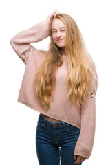 Sticker - Blonde teenager woman wearing pink sweater confuse and wonder about question. Uncertain with doubt, thinking with hand on head. Pensive concept.