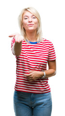 Poster - Young beautiful blonde woman over isolated background looking at the camera blowing a kiss with hand on air being lovely and sexy. Love expression.