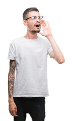 Sticker - Young tattooed adult man shouting and screaming loud to side with hand on mouth. Communication concept.