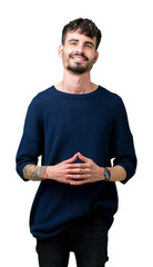 Wall Mural - Young handsome man over isolated background Hands together and fingers crossed smiling relaxed and cheerful. Success and optimistic