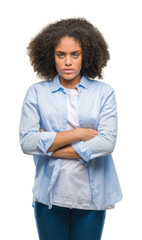 Sticker - Young afro american woman over isolated background skeptic and nervous, disapproving expression on face with crossed arms. Negative person.