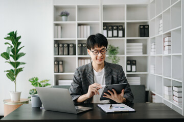 Young business man executive manager looking at laptop watching online webinar training or having virtual meeting video conference doing market research working in office...
