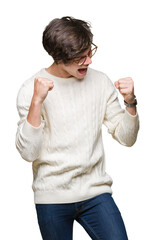 Wall Mural - Young handsome man wearing glasses over isolated background very happy and excited doing winner gesture with arms raised, smiling and screaming for success. Celebration concept.