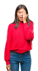 Sticker - Young asian woman wearing winter sweater over isolated background covering one eye with hand with confident smile on face and surprise emotion.