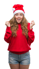 Poster - Young blonde woman wearing santa claus hat screaming proud and celebrating victory and success very excited, cheering emotion