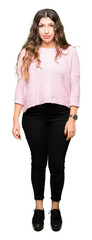 Sticker - Young beautiful woman wearing pink sweater Relaxed with serious expression on face. Simple and natural looking at the camera.