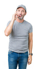 Sticker - Handsome middle age hoary senior man wearing sport cap over isolated background mouth and lips shut as zip with fingers. Secret and silent, taboo talking