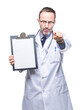 © Krakenimages.com - Middle age senior hoary doctor man holding clipboard isolated background pointing with finger to the camera and to you, hand sign, positive and confident gesture from the front