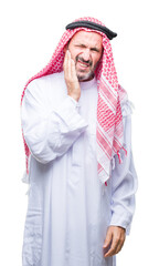 Sticker - Senior arab man wearing keffiyeh over isolated background touching mouth with hand with painful expression because of toothache or dental illness on teeth. Dentist concept.