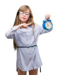 Sticker - Young blonde child holding alarm clock very happy pointing with hand and finger