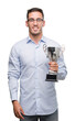 © Krakenimages.com - Handsome young man holding trophy with a happy face standing and smiling with a confident smile showing teeth