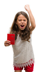 Poster - Brunette hispanic girl holding passport of Switzerland annoyed and frustrated shouting with anger, crazy and yelling with raised hand, anger concept