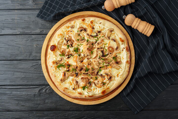 Fresh tasty pizza on black wooden background