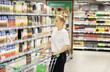 © lado2016 - supermarket shopping,Woman choosing a dairy products at supermarket.