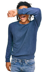 Wall Mural - Young african american man wearing casual winter sweater covering eyes with arm smiling cheerful and funny. blind concept.