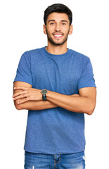 Young handsome man wearing casual clothes happy face smiling with crossed arms looking at the camera. positive person.