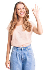 Sticker - Young beautiful caucasian woman with blond hair wearing casual clothes smiling positive doing ok sign with hand and fingers. successful expression.