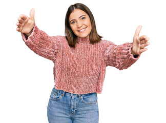 Poster - Young beautiful woman wearing casual clothes looking at the camera smiling with open arms for hug. cheerful expression embracing happiness.