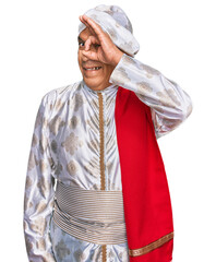 Poster - Senior hispanic man wearing tradition sherwani saree clothes doing ok gesture with hand smiling, eye looking through fingers with happy face.