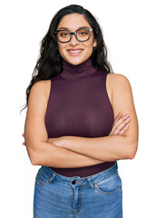 Wall Mural - Brunette young woman wearing casual clothes and glasses happy face smiling with crossed arms looking at the camera. positive person.