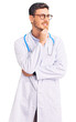 © Krakenimages.com - Handsome young man with bear wearing doctor uniform with hand on chin thinking about question, pensive expression. smiling with thoughtful face. doubt concept.