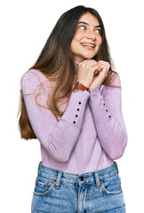 Canvas Print - Young beautiful teen girl wearing turtleneck sweater laughing nervous and excited with hands on chin looking to the side