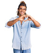 © Krakenimages.com - Young hispanic man wearing summer style smiling in love doing heart symbol shape with hands. romantic concept.