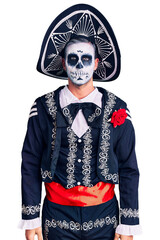 Sticker - Young man wearing day of the dead costume over background relaxed with serious expression on face. simple and natural looking at the camera.