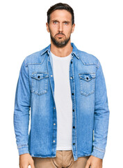 Poster - Young handsome man wearing casual denim jacket depressed and worry for distress, crying angry and afraid. sad expression.