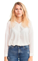 Wall Mural - Young beautiful blonde woman wearing casual shirt with serious expression on face. simple and natural looking at the camera.