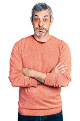 Poster - Middle age hispanic man with grey hair with arms crossed gesture puffing cheeks with funny face. mouth inflated with air, catching air.