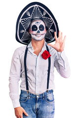 Poster - Man wearing day of the dead costume over background showing and pointing up with fingers number five while smiling confident and happy.