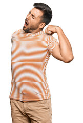 Canvas Print - Handsome hispanic man wearing casual clothes stretching back, tired and relaxed, sleepy and yawning for early morning