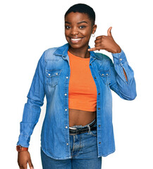 Canvas Print - Young african american woman wearing casual clothes smiling doing phone gesture with hand and fingers like talking on the telephone. communicating concepts.