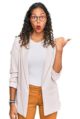 Poster - Young african american girl wearing business clothes surprised pointing with hand finger to the side, open mouth amazed expression.