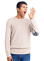 Wall Mural - Young african amercian man wearing casual clothes shouting and screaming loud to side with hand on mouth. communication concept.