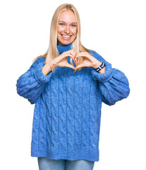 Sticker - Young blonde girl wearing wool winter sweater smiling in love showing heart symbol and shape with hands. romantic concept.