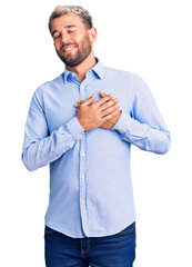 Poster - Young handsome blond man wearing elegant shirt smiling with hands on chest with closed eyes and grateful gesture on face. health concept.