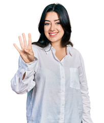 Wall Mural - Beautiful hispanic woman wearing casual white shirt showing and pointing up with fingers number four while smiling confident and happy.