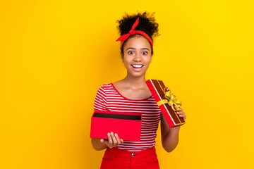 Sticker - Photo of excited positive small girl toothy smile hands hold open desirable giftbox isolated on yellow color background