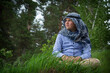 © Олеся Тамилович - In summer, a boy in an Arab scarf sits on the grass.