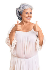 Poster - Senior woman with gray hair wearing bohemian style success sign doing positive gesture with hand, thumbs up smiling and happy. cheerful expression and winner gesture.