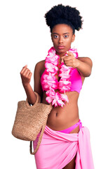 Canvas Print - Young african american woman wearing bikini and hawaiian lei pointing with finger to the camera and to you, confident gesture looking serious