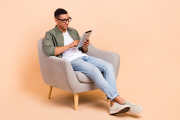 Canvas Print - Full length photo of intelligent guy dressed khaki shirt glasses jeans look at tablet texting email isolated on pastel color background