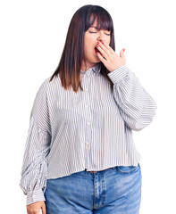 Poster - Young plus size woman wearing casual clothes bored yawning tired covering mouth with hand. restless and sleepiness.