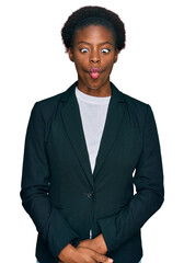 Wall Mural - Young african american girl wearing business clothes making fish face with lips, crazy and comical gesture. funny expression.